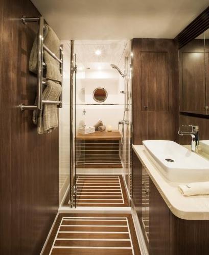 Slide: The Image of Luxurious bathroom in 2024 Belize 66 Sedan yacht with modern fixtures and wooden accents. - 16