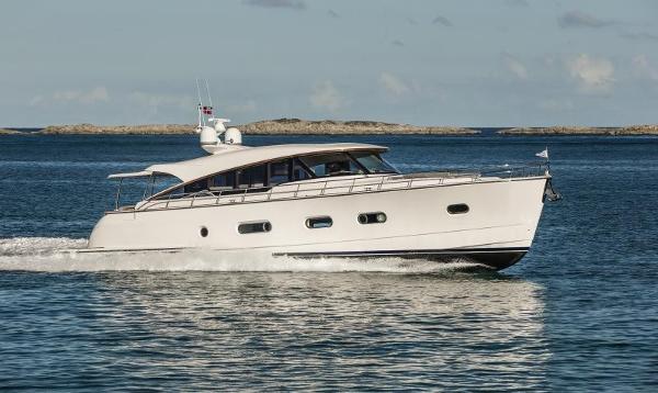 Slide: The Image of 2024 Belize 66 Sedan yacht cruising on open water. - 2