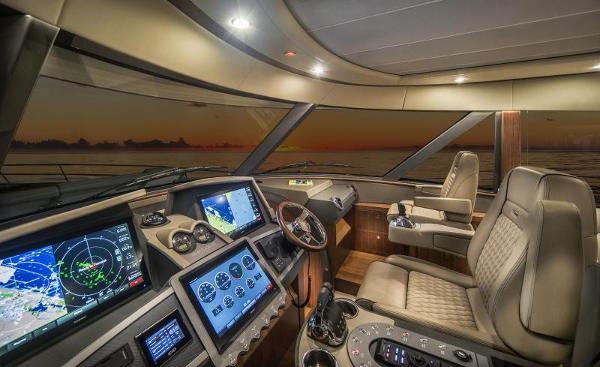 Slide: The Image of Luxurious cockpit of the 2024 Belize 66 Sedan yacht at sunset. - 9