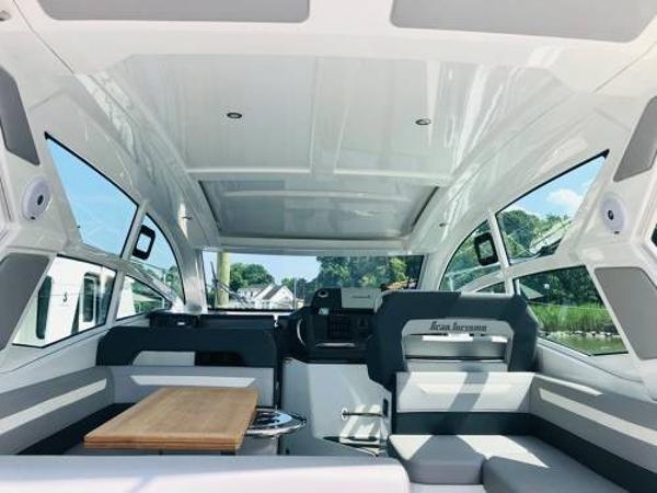 Slide: The Image of Interior of 2024 Beneteau 36 Gran Turismo GT yacht with modern seating and panoramic windows. - 14