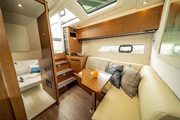 Slide: The Image of Interior of 2024 Beneteau 36 Gran Turismo GT yacht with modern seating and wooden finishes. - 26