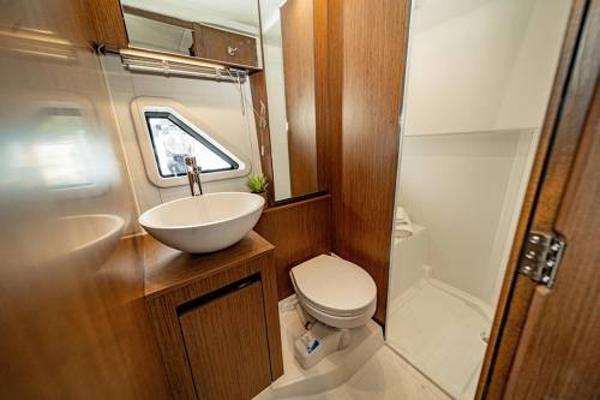 Slide: The Image of Modern bathroom in 2024 Beneteau 36 Gran Turismo GT yacht with wood accents. - 29