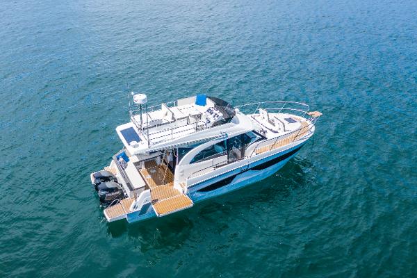 Slide: The Image of 2025 Beneteau Antares 11 Fly yacht on open water, aerial view. - 0