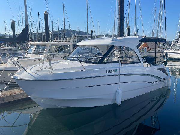 Slide: The Image of 2022 Beneteau Antares 7 boat docked in a marina. - 2