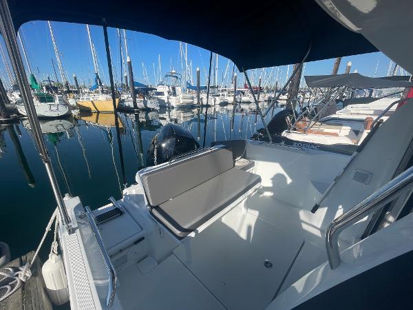 Slide: The Image of 2022 Beneteau Antares 7 boat docked at a marina with other boats. - 5