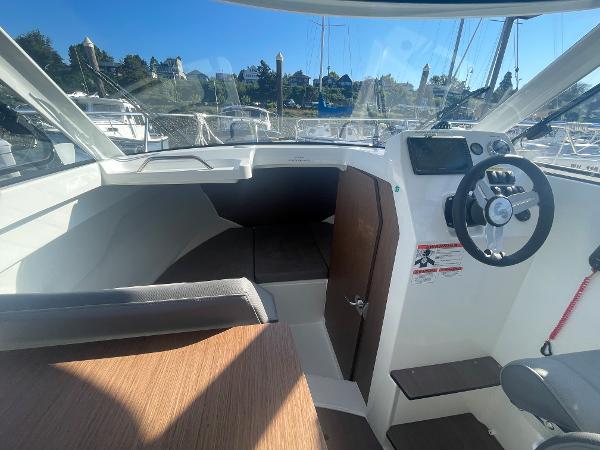 Slide: The Image of 2022 Beneteau Antares 7 boat interior with steering wheel and navigation equipment. - 7