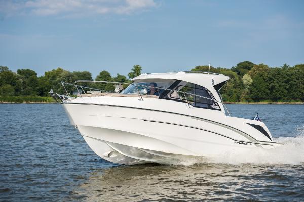 Slide: The Image of 2025 Beneteau Antares 7 cruising on a serene lake with lush green trees. - 2