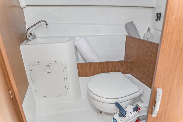 Slide: The Image of 2025 Beneteau Antares 7 boat bathroom with compact toilet and sink. - 8