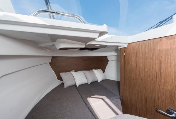 Slide: The Image of 2025 Beneteau Antares 7 cabin interior with cozy bedding and modern design. - 9