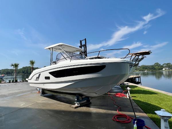 Slide: The Image of 2024 Beneteau Flyer 9 SUNdeck boat docked by a serene lake. - 0
