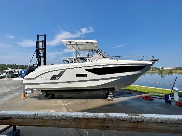 Slide: The Image of 2024 Beneteau Flyer 9 SUNdeck boat on display at a marina. - 1