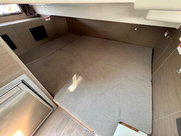 Slide: The Image of 2024 Beneteau Flyer 9 SUNdeck cabin interior with bed and storage compartments. - 11