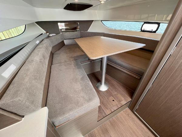 Slide: The Image of 2024 Beneteau Flyer 9 SUNdeck interior with cozy seating and dining table. - 12