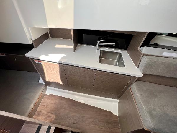 Slide: The Image of Modern kitchenette in 2024 Beneteau Flyer 9 SUNdeck boat with sink and storage. - 14