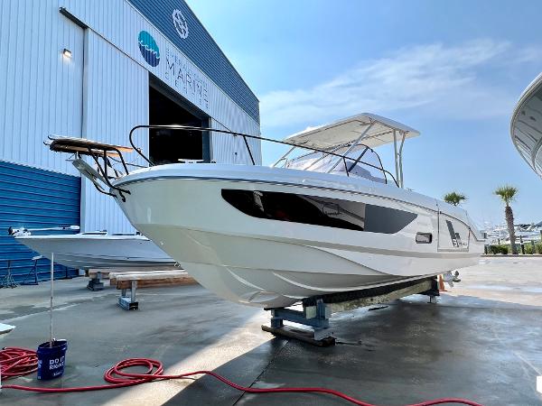 Slide: The Image of 2024 Beneteau Flyer 9 SUNdeck boat on display at a marina. - 2