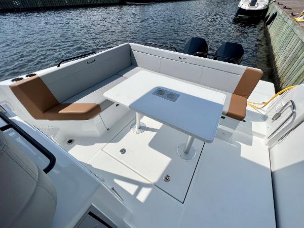 Slide: The Image of 2024 Beneteau Flyer 9 SUNdeck boat with spacious seating and table on deck. - 23