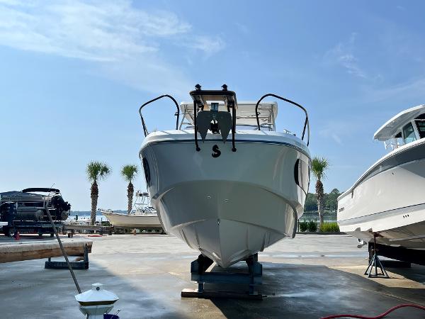 Slide: The Image of 2024 Beneteau Flyer 9 SUNdeck boat on dry dock under a clear blue sky. - 3