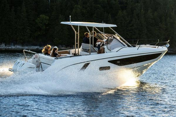 Slide: The Image of 2024 Beneteau Flyer 9 SUNdeck cruising on a serene lake with passengers onboard. - 4