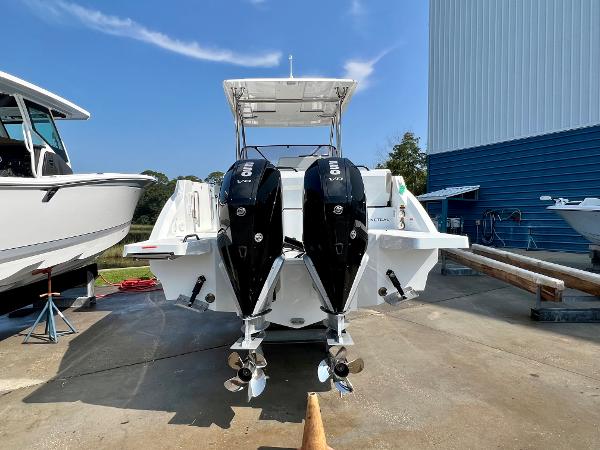 Slide: The Image of 2024 Beneteau Flyer 9 SUNdeck with twin outboard engines, docked at a marina. - 5