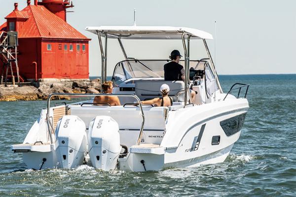 Slide: The Image of 2024 Beneteau Flyer 9 SUNdeck cruising near a red lighthouse on a sunny day. - 6
