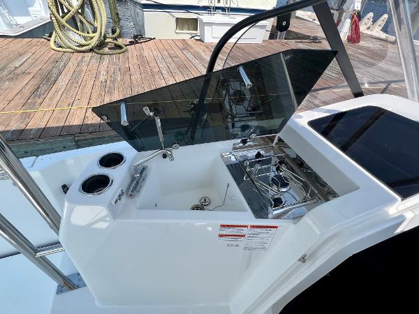 Slide: The Image of 2024 Beneteau Flyer 9 SUNdeck boat kitchen area with sink and stove. - 9