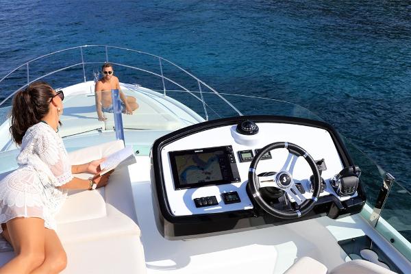 Slide: The Image of 2021 Beneteau Gran Turismo 50 Sportfly yacht with people relaxing on deck. - 12