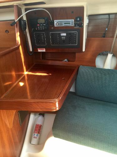 Slide: The Image of Beneteau Oceanis 321 yacht interior, 2000 model, featuring navigation equipment and wooden finish. - 20