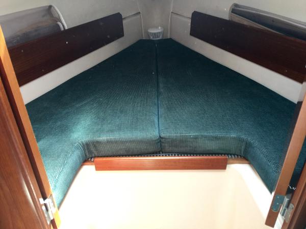 Slide: The Image of Interior cabin of 2000 Beneteau Oceanis 321 sailboat with green cushions. - 21