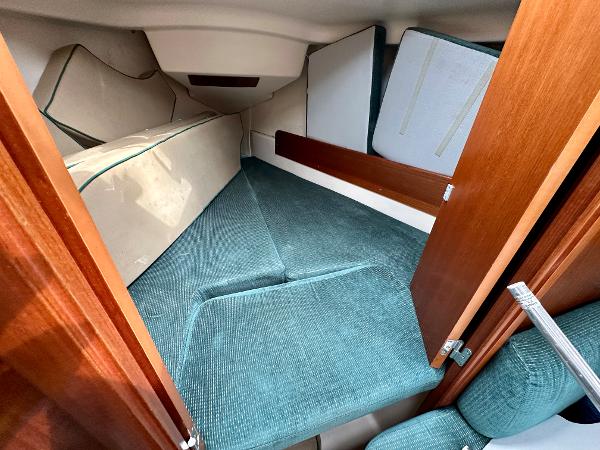 Slide: The Image of Cozy cabin interior of 2000 Beneteau Oceanis 321 sailboat with teal upholstery. - 23