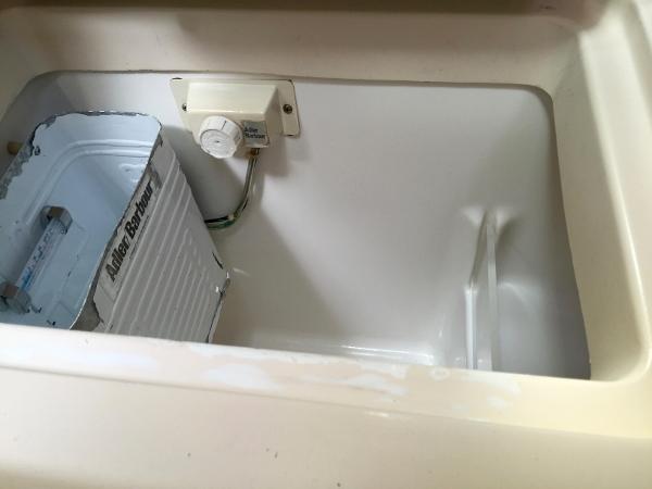 Slide: The Image of Interior of Beneteau Oceanis 321 (2000) showing a storage compartment with a can. - 28