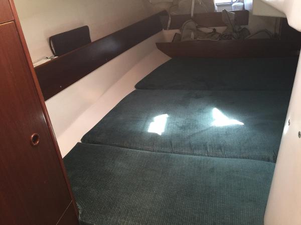 Slide: The Image of Interior cabin of 2000 Beneteau Oceanis 321 sailboat with green cushions. - 31