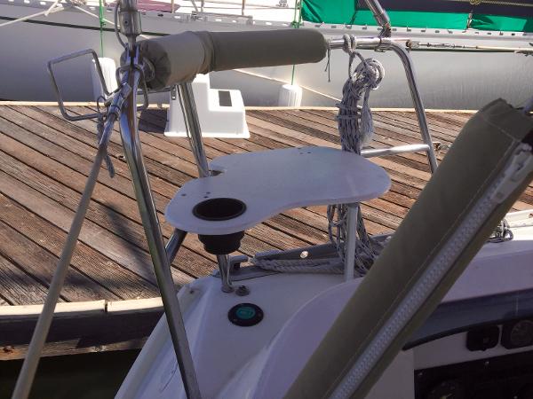 Slide: The Image of Beneteau Oceanis 321 sailboat cockpit detail, featuring a small table and railing, docked at a marina. - 38