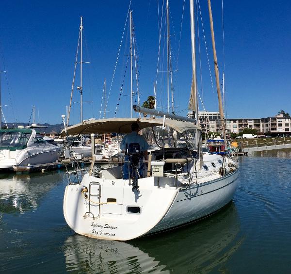 Slide: The Image of Beneteau Oceanis 321 sailboat from 2000 docked in a marina under clear blue skies. - 44