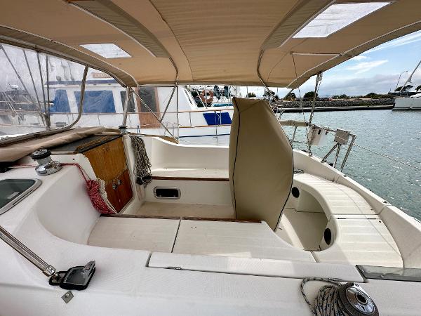 Slide: The Image of Beneteau Oceanis 321 sailboat cockpit, 2000 model, featuring spacious seating and protective canopy. - 7