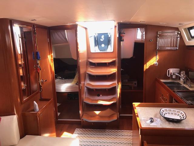 Slide: The Image of Interior of 2013 Beneteau Oceanis 45 sailboat with wooden cabinetry and modern kitchen. - 29