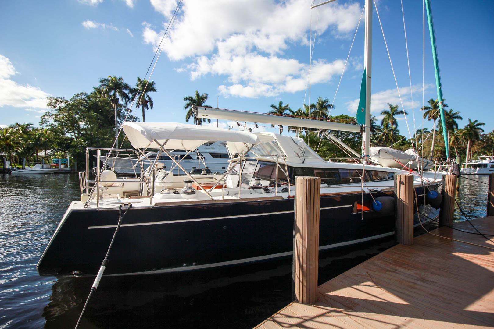 Slide: The Image of 2015 Beneteau Sense 55 sailboat docked at a marina on a sunny day. - 0