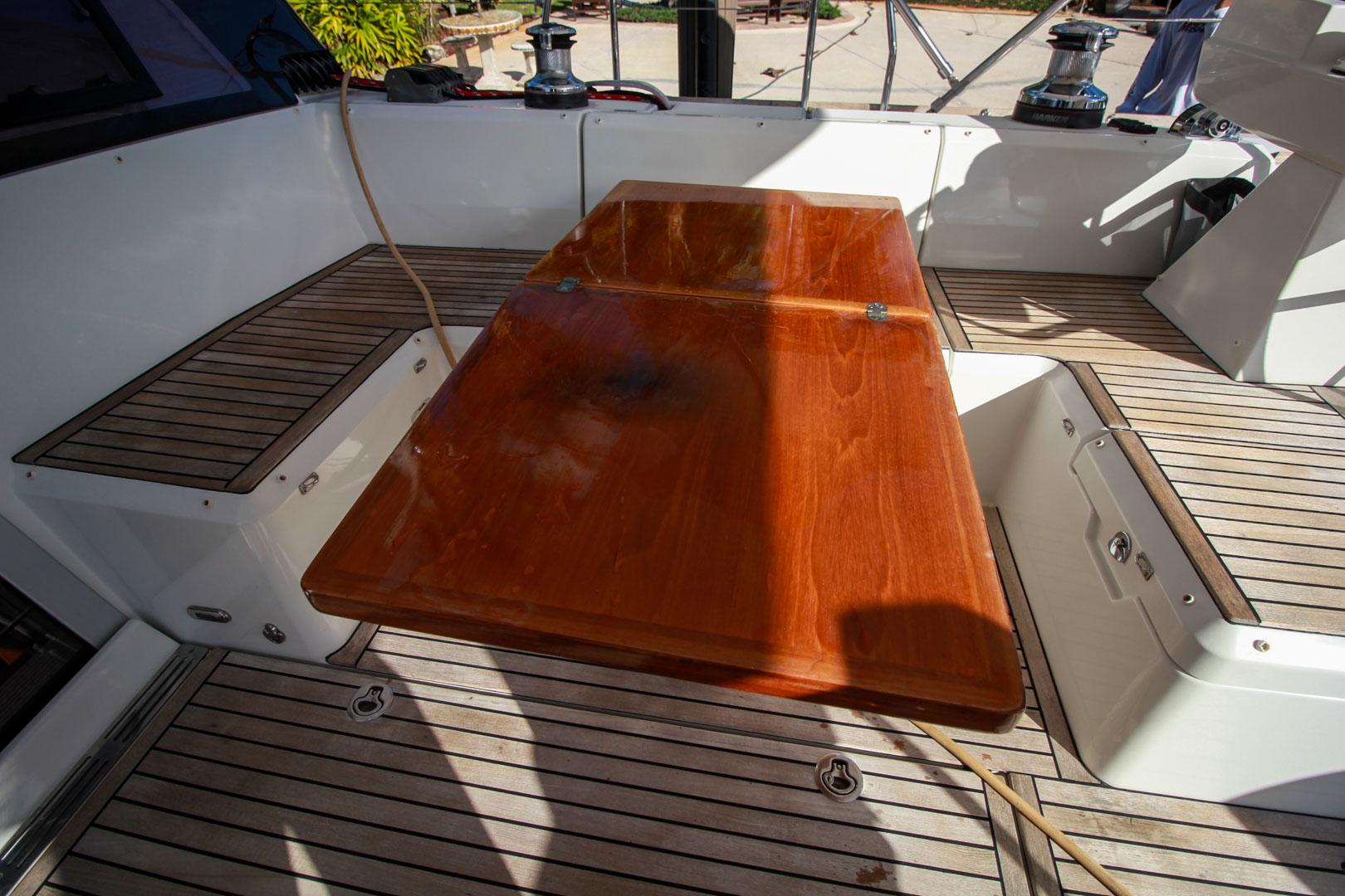 Slide: The Image of Cockpit of 2015 Beneteau Sense 55 yacht with wooden table and seating. - 15