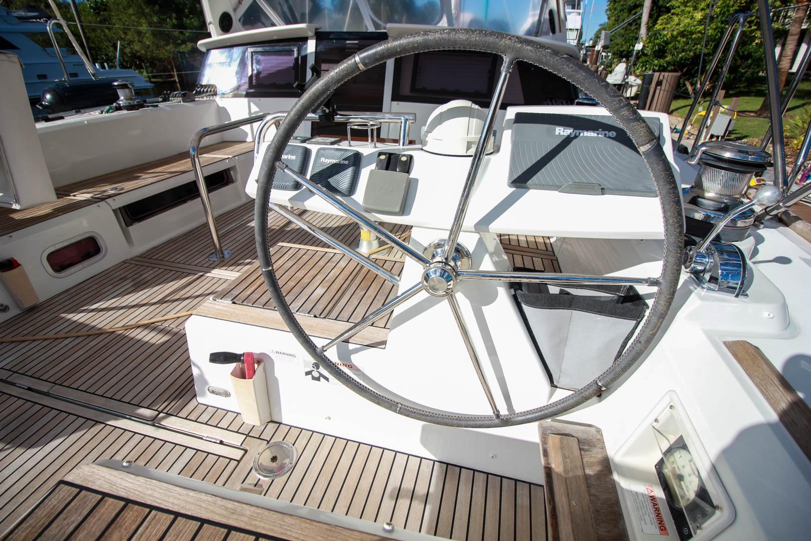 Slide: The Image of Cockpit of 2015 Beneteau Sense 55 sailboat with steering wheel and navigation equipment. - 18