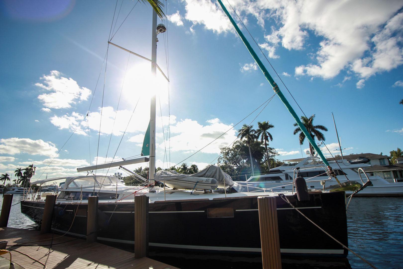 Slide: The Image of 2015 Beneteau Sense 55 sailboat docked under a sunny sky. - 2