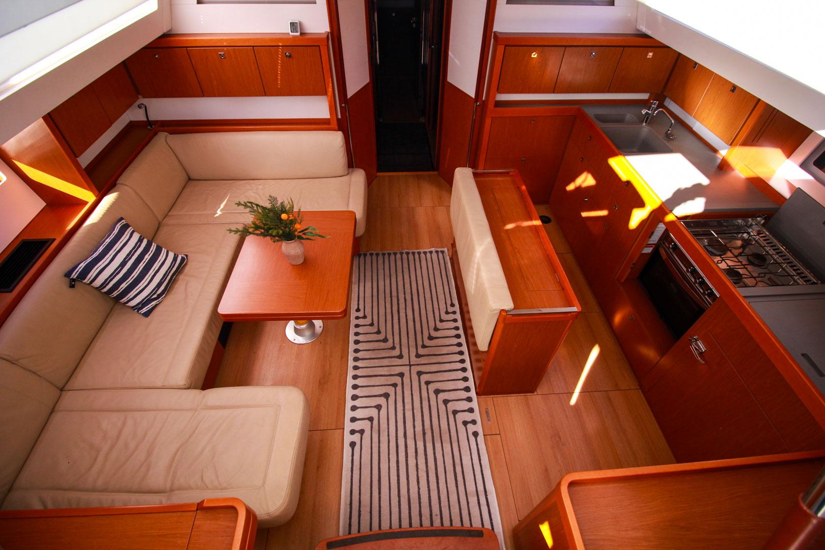 Slide: The Image of Interior of 2015 Beneteau Sense 55 yacht with modern kitchen and cozy seating area. - 30