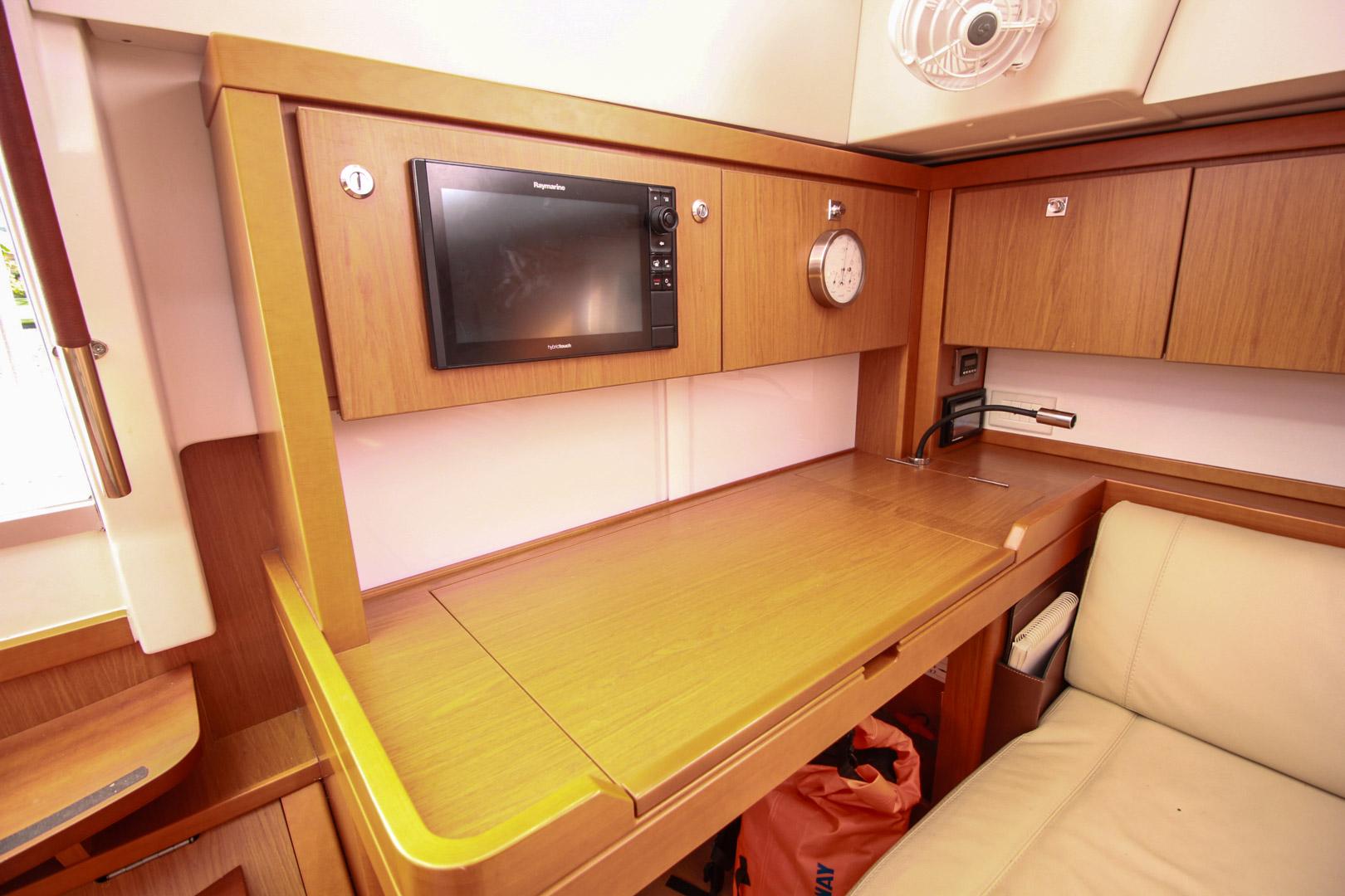 Slide: The Image of Navigation station on a 2015 Beneteau Sense 55 yacht with Raymarine equipment. - 31