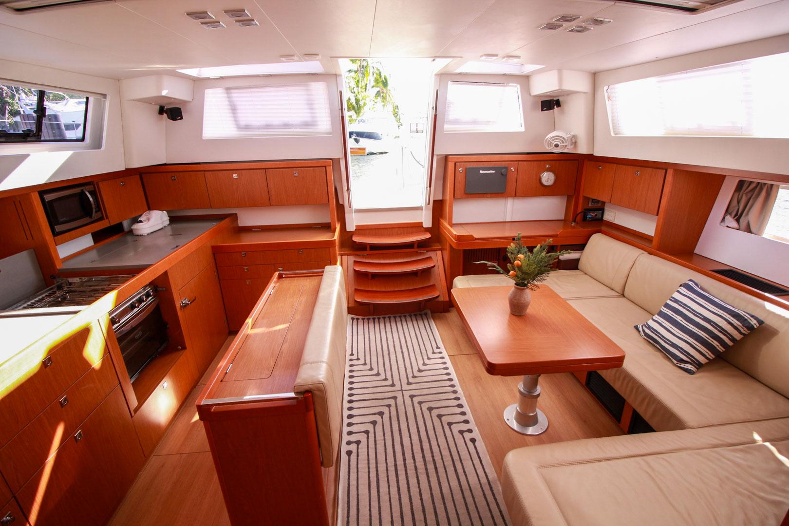 Slide: The Image of Interior of 2015 Beneteau Sense 55 yacht with modern kitchen and cozy seating area. - 32