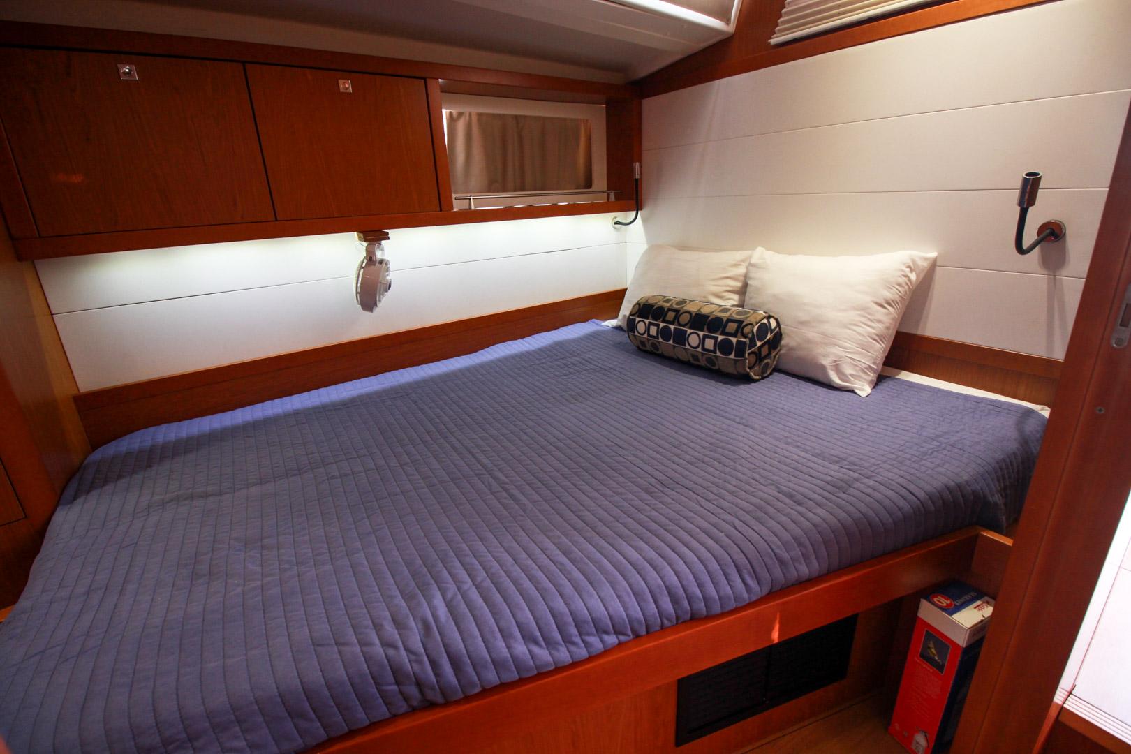 Slide: The Image of Interior cabin of 2015 Beneteau Sense 55 yacht with bed and storage cabinets. - 42