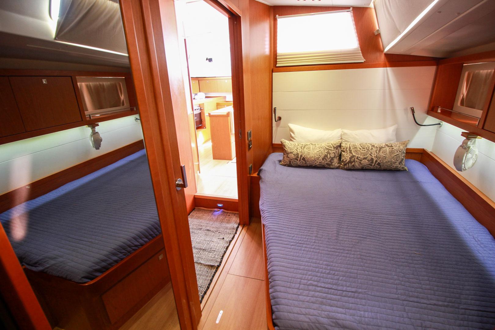 Slide: The Image of Luxurious bedroom interior of 2015 Beneteau Sense 55 yacht with blue bedding and wooden finishes. - 43