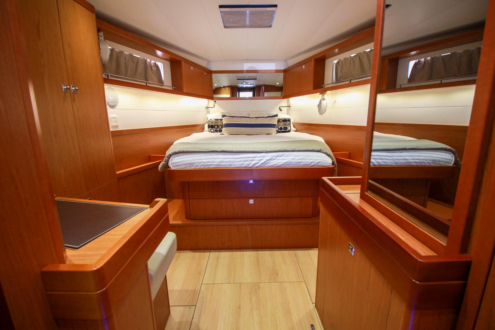 Slide: The Image of Luxurious master cabin of 2015 Beneteau Sense 55 yacht with wooden furnishings and cozy bed. - 46