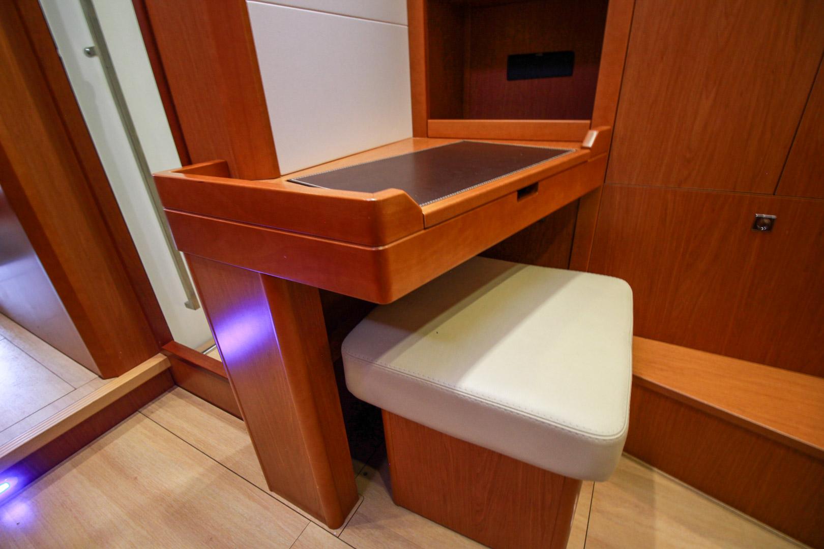 Slide: The Image of Interior desk and seat in 2015 Beneteau Sense 55 yacht, featuring wooden finish and modern design. - 47