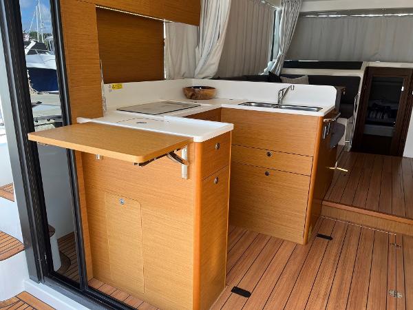 Slide: The Image of Interior of 2021 Beneteau Swift Trawler 41 with modern kitchen and wooden flooring. - 11