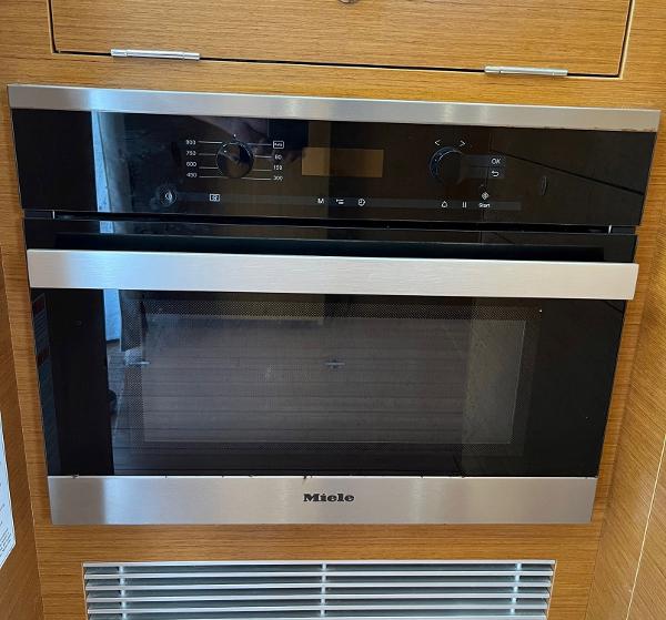 Slide: The Image of Miele oven in 2021 Beneteau Swift Trawler 41 kitchen, featuring sleek design and modern controls. - 14