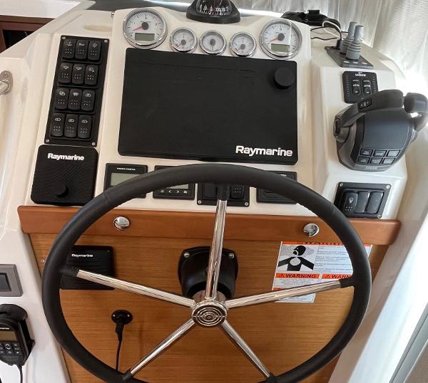 Slide: The Image of Steering wheel and control panel of 2021 Beneteau Swift Trawler 41 with Raymarine equipment. - 19