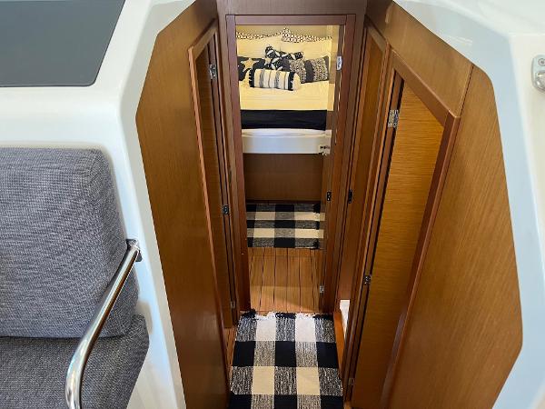 Slide: The Image of Interior view of 2021 Beneteau Swift Trawler 41, featuring wood paneling and checkered rugs. - 21